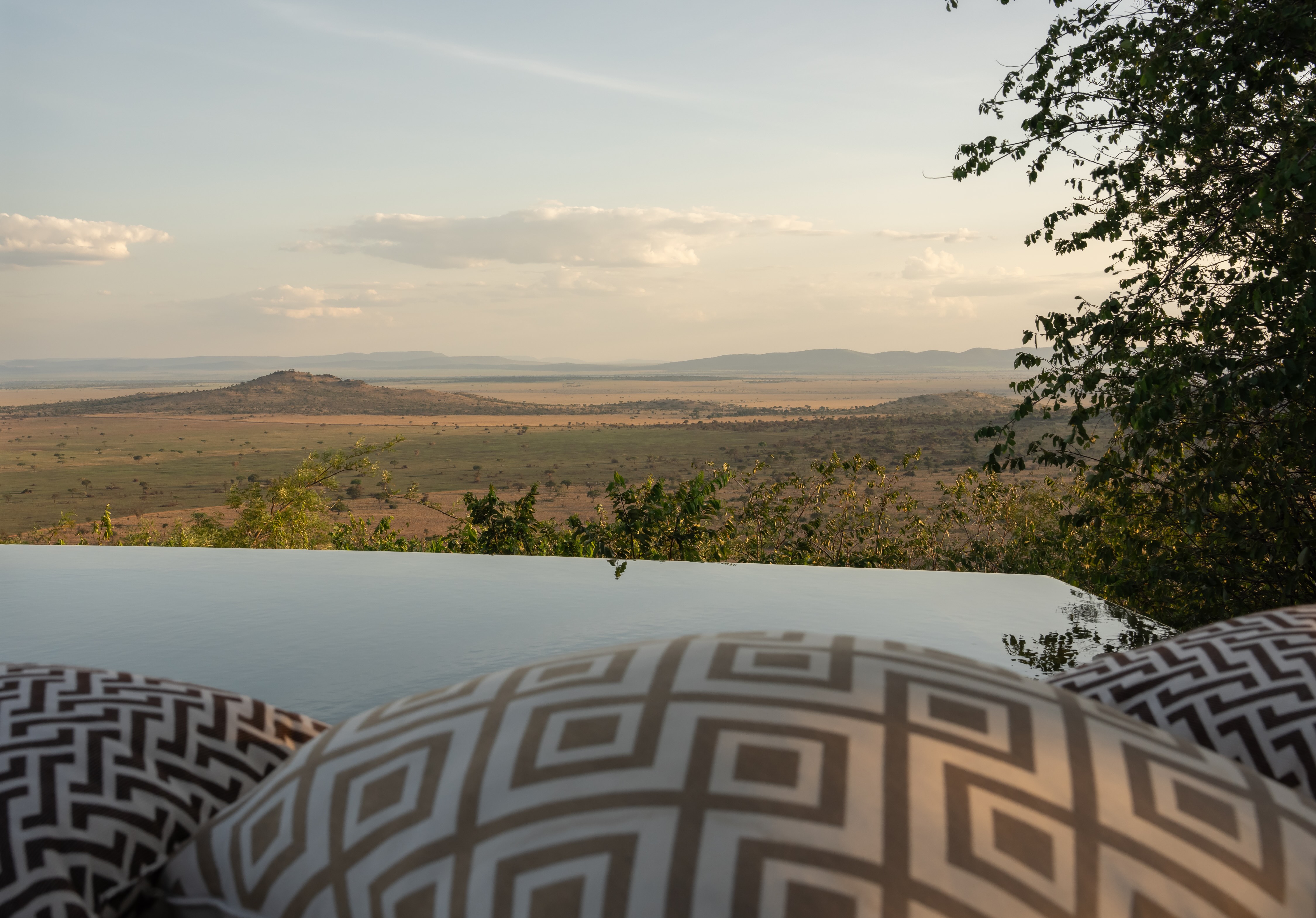 Lodge perched above the plains for dramatic sunrises, sunsets, and uninterrupted wildlife views.