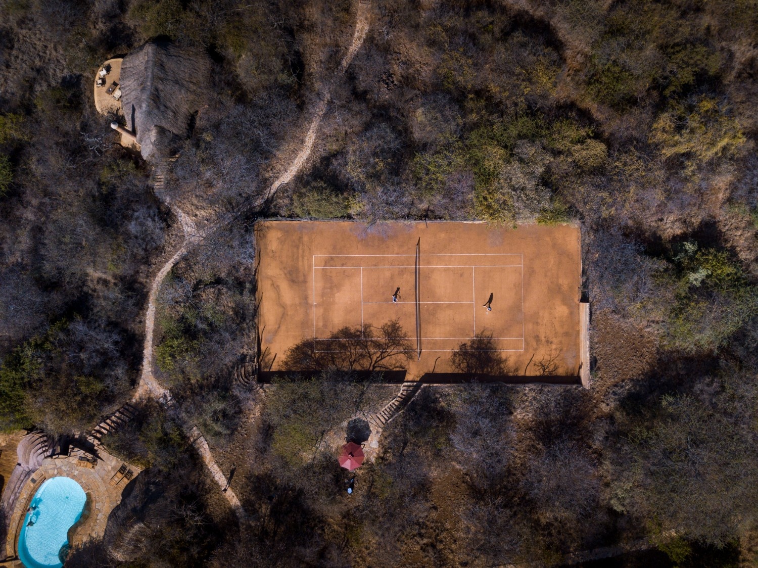 Relax in the infinity pool with panoramic views or challenge friends and family on the full-size tennis court.