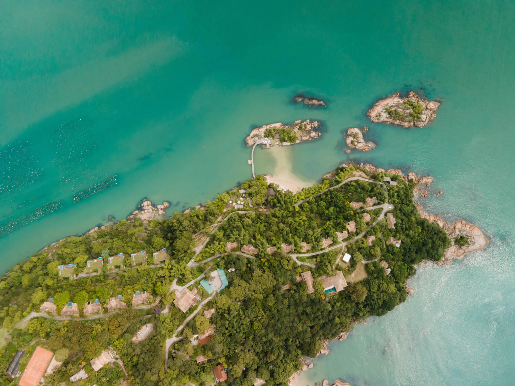 Private accommodations immersed between rainforest and ocean landscapes.