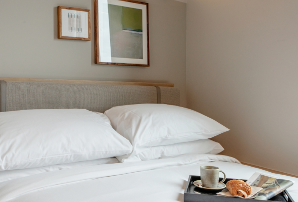 Compact rooms are intentionally designed around efficiency, comfort and smart technology, with natural fabrics, earthy colors and plush beds.