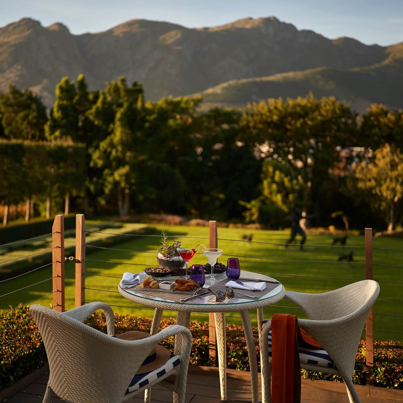 Luxury accommodation immersed among vineyards and mountain scenery.

