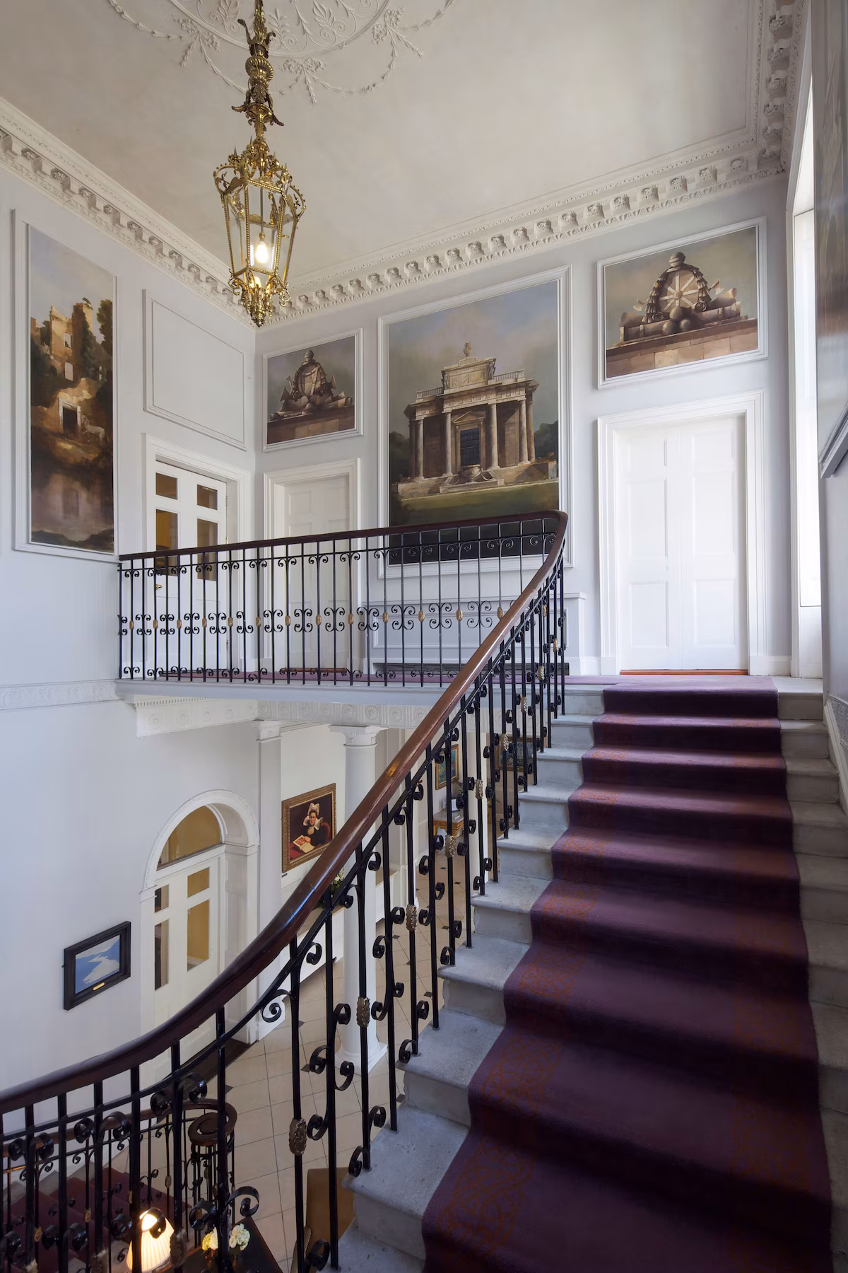 Four Georgian townhouses have been restored into an elegant five-star hotel while retaining historic details including rococo plasterwork, vaulted ceilings and marble fireplaces.
