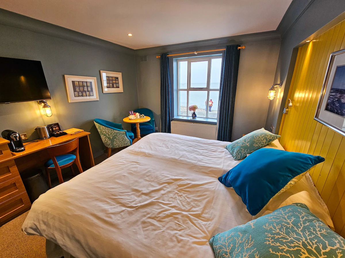 Lighthouse-inspired room names, en-suite accommodation, sea views and coastal detailing create a distinctly Howth character. 