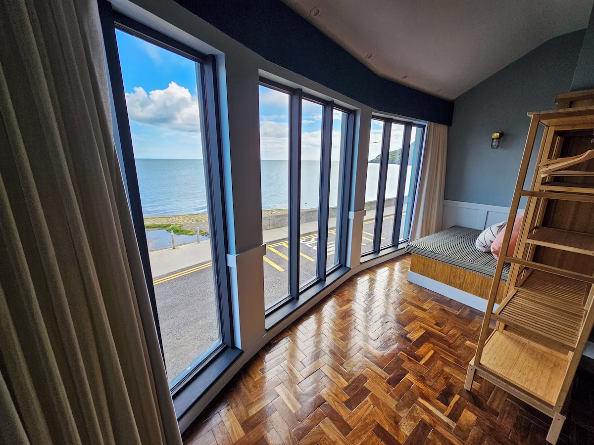Ten bedrooms look across Balscadden Bay and the harbour, with nautical styling and individual coastal perspectives.