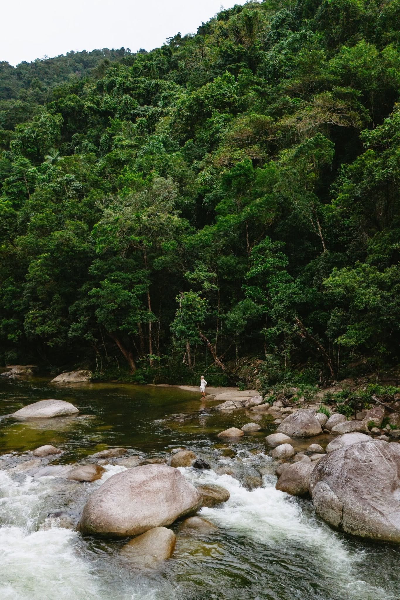 Crystal-clear rainforest waters flow directly beside the lodge, creating an atmosphere of complete relaxation and natural beauty.