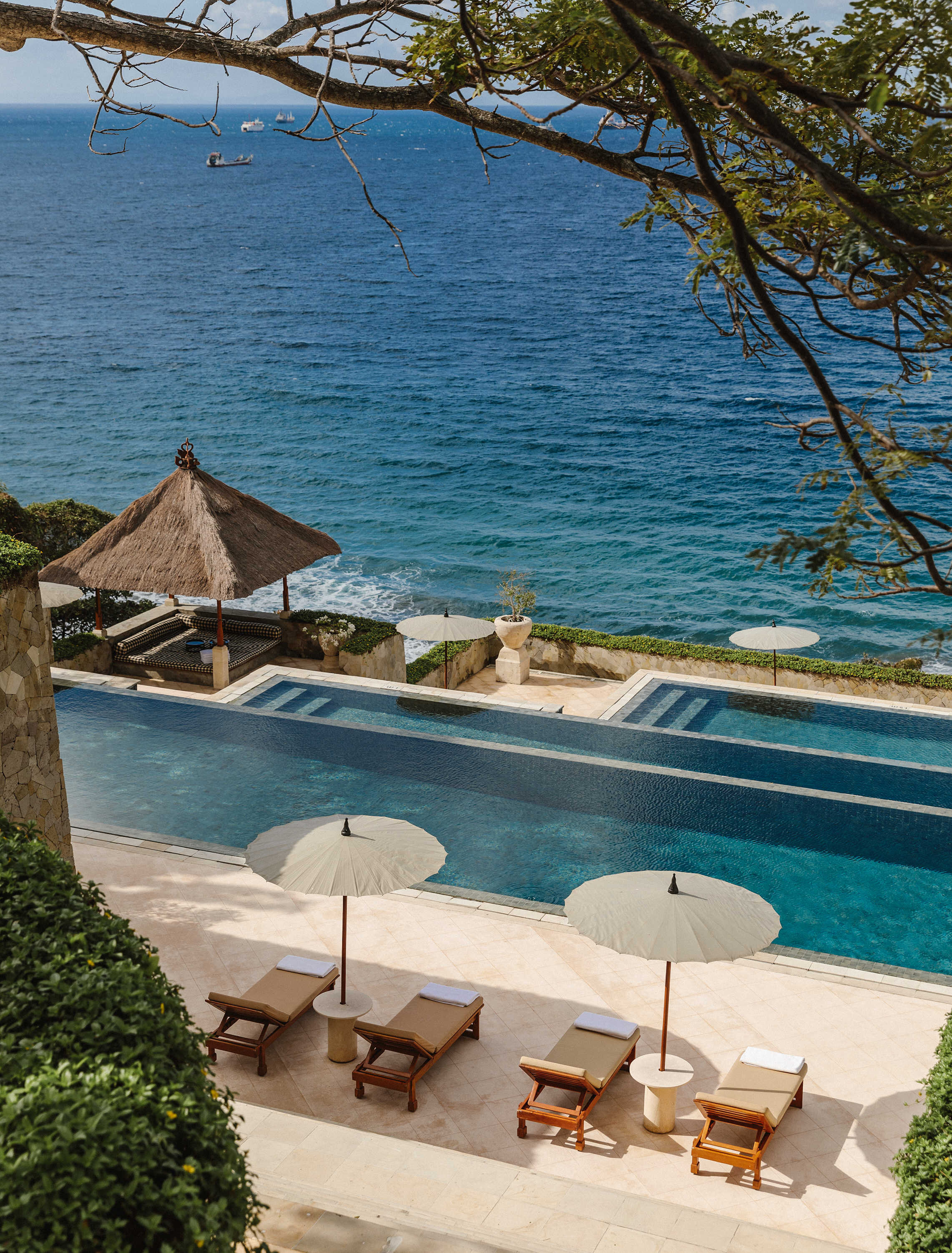 A signature three-tier infinity pool cascades through the heart of the property.