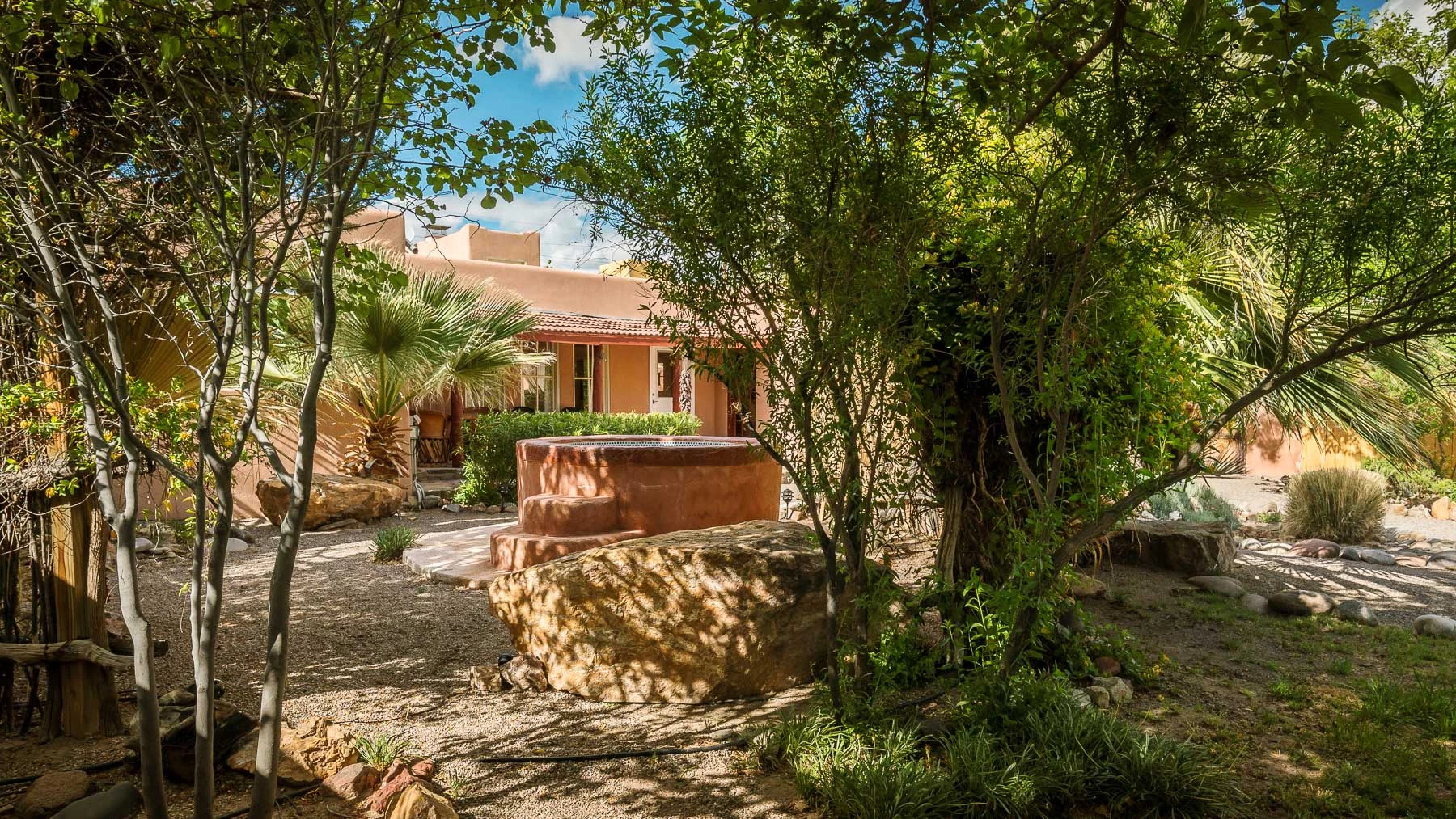 The adobe-style Casita features two bedrooms, two bathrooms, a family room, wood-burning fireplace, indoor/outdoor hot-spring tubs and a private courtyard.