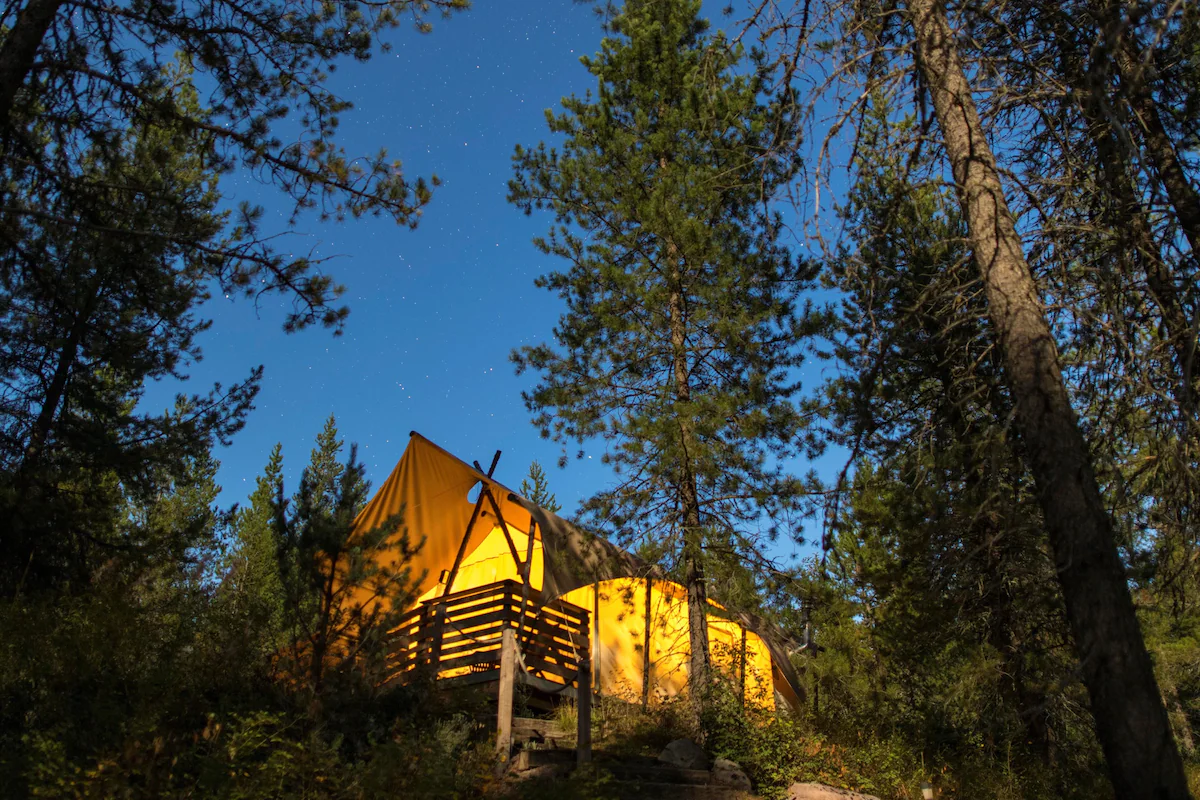 Selected accommodations feature overhead viewing windows positioned above the bed, allowing guests to fall asleep beneath Montana's breathtaking star-filled skies.