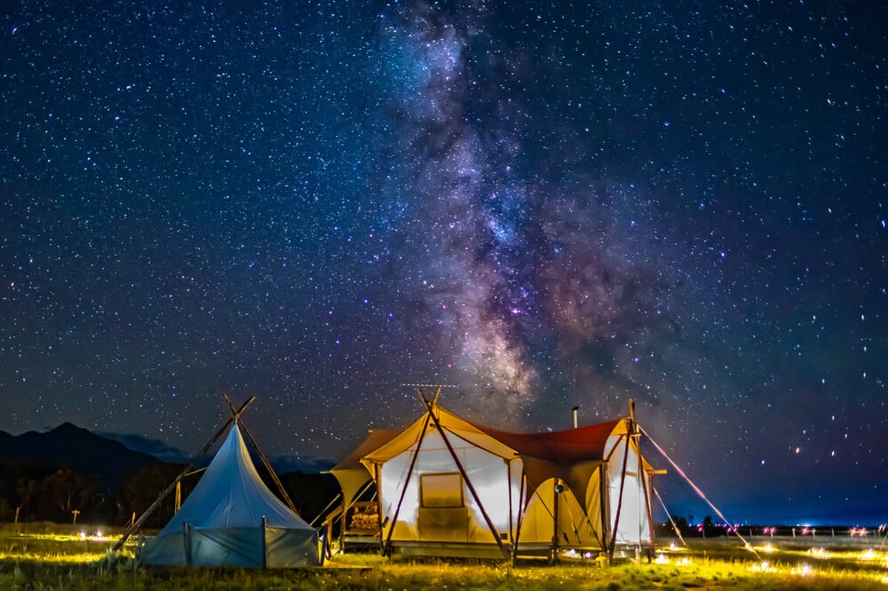 Selected accommodations feature overhead viewing windows positioned above the bed, allowing guests to fall asleep beneath Montana's brilliantly clear night skies.