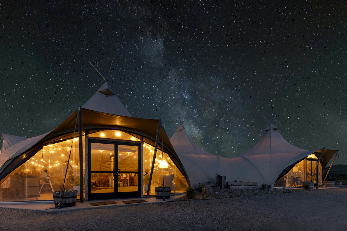 Selected accommodations feature overhead viewing windows positioned above the bed, allowing guests to fall asleep beneath Montana's breathtaking star-filled skies.