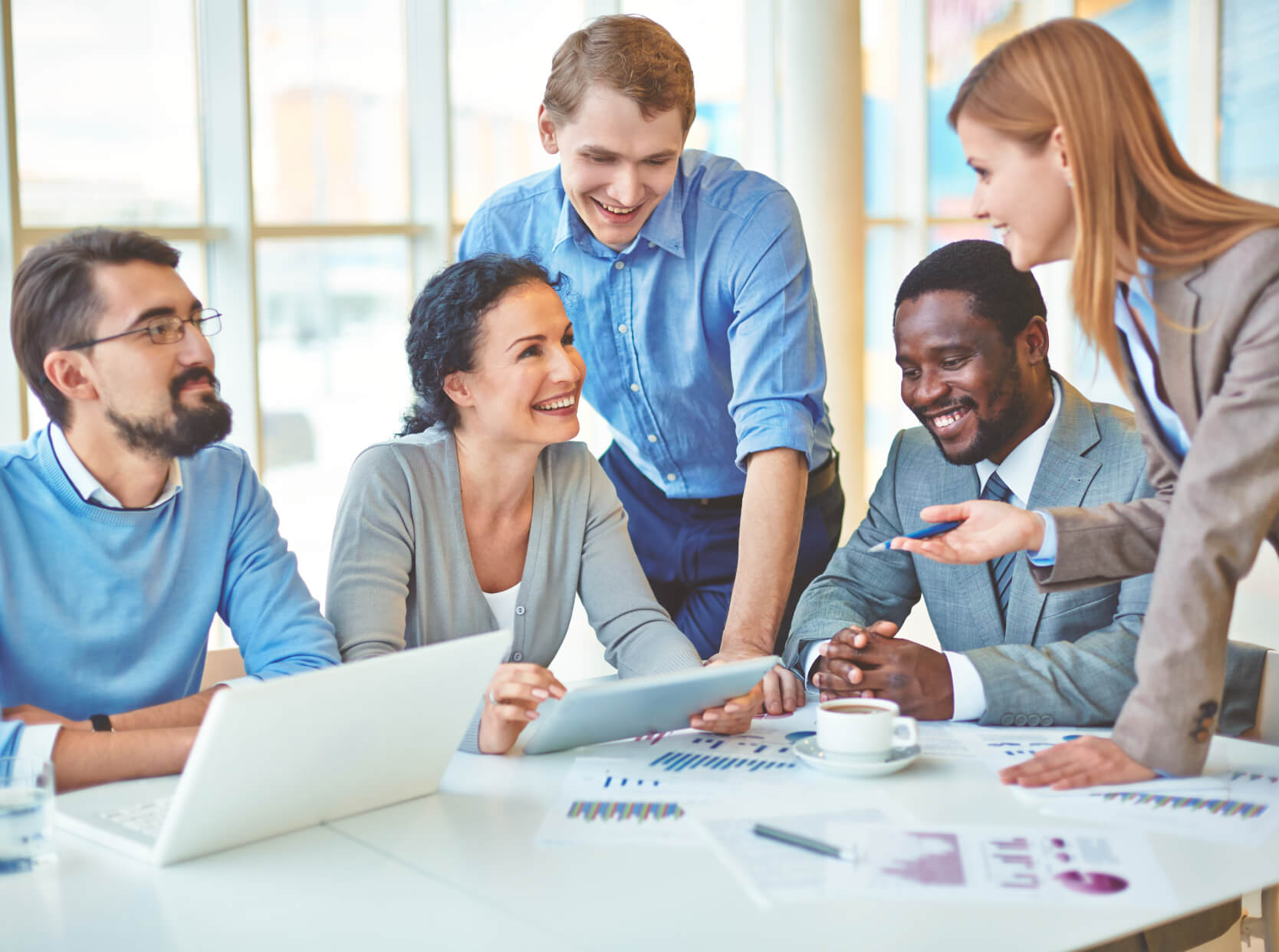 A group of people standing around a table.