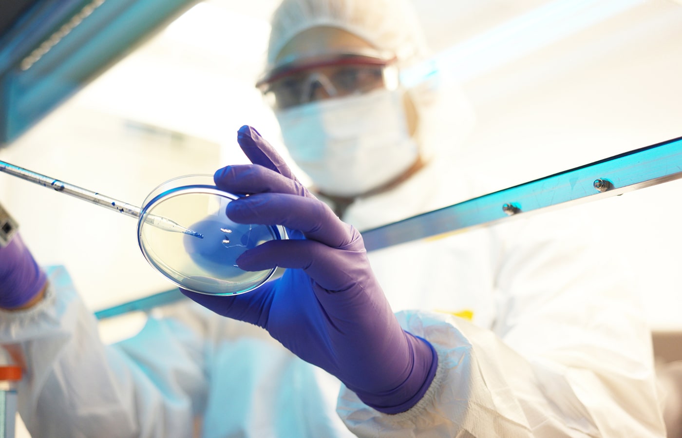 Lab technician conducting R&D for non-viral gene therapy at Genexys BioMed.