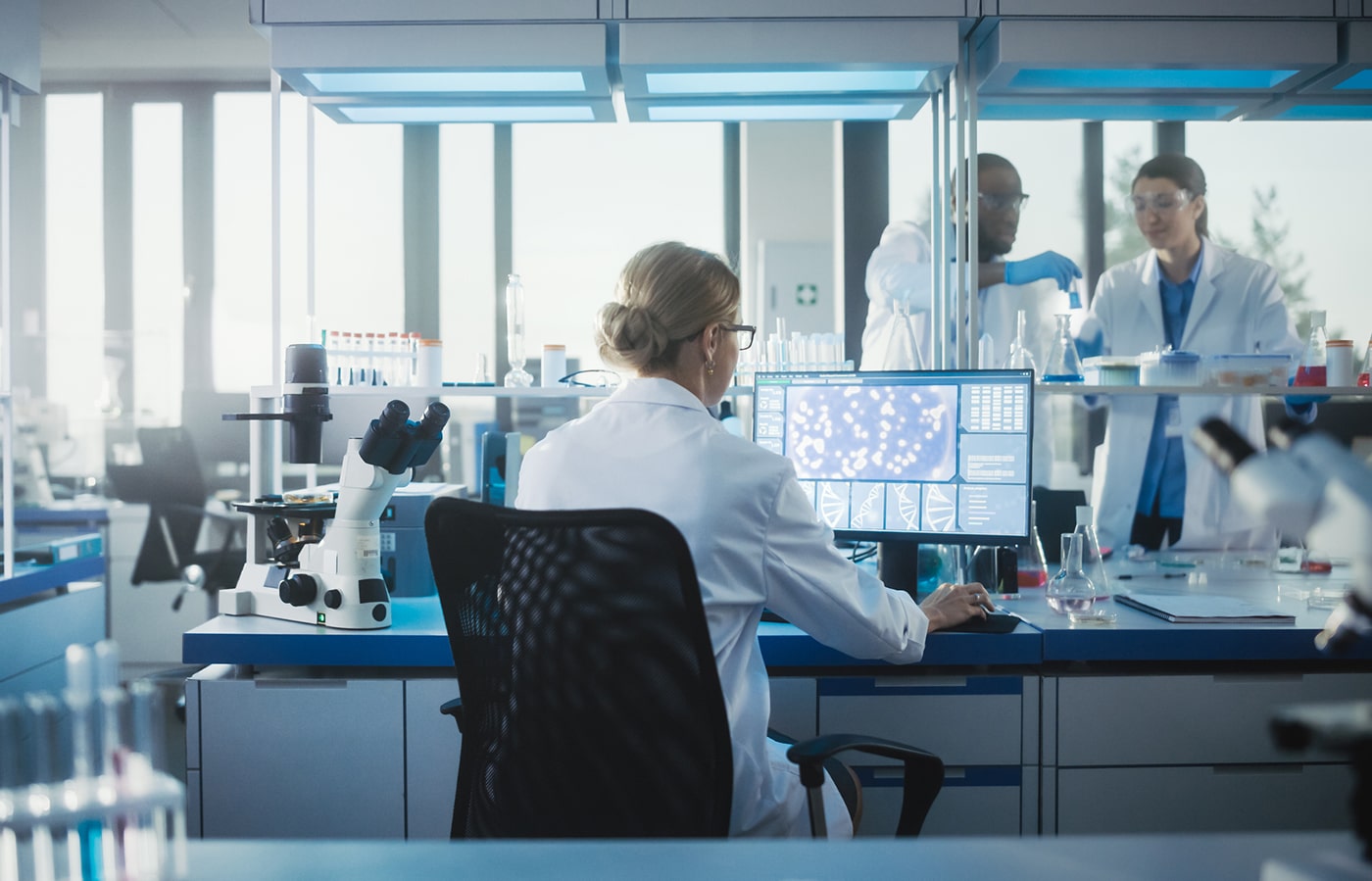 Scientist analyzing CF gene therapy data in a modern research lab.