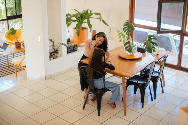 Photo of a woman and child sat at a table 