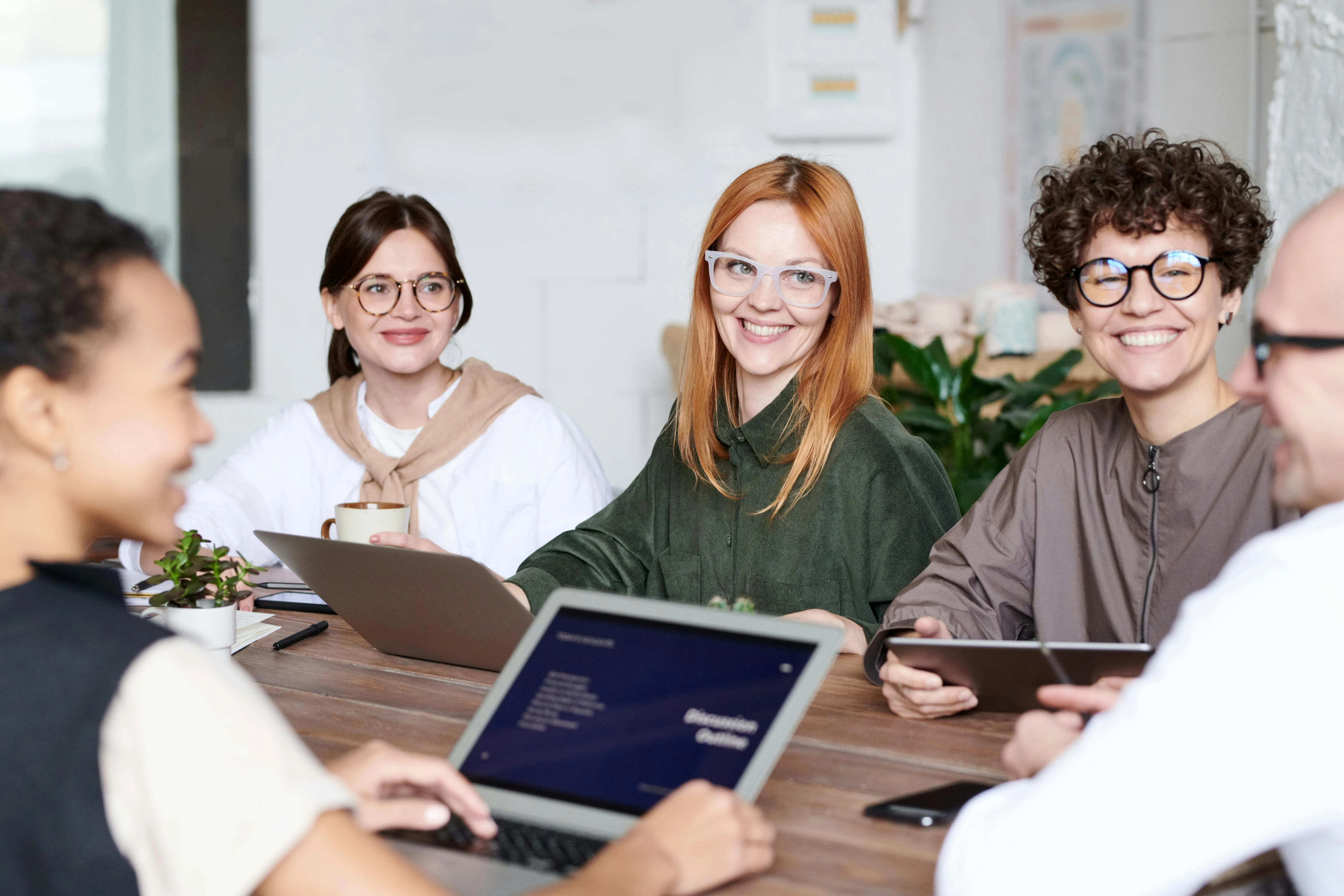 People in office with glasses smiling