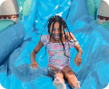 Child going down slide at camp skylark