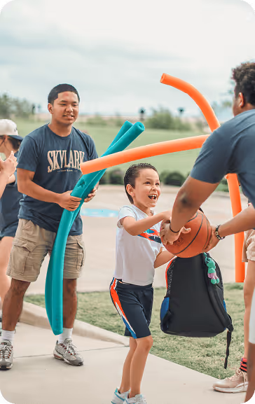 Camp directors and children playing