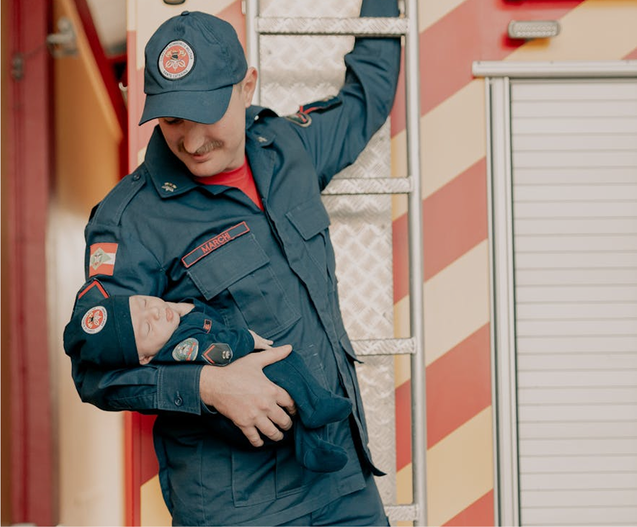Fire fighter bring baby while climbing