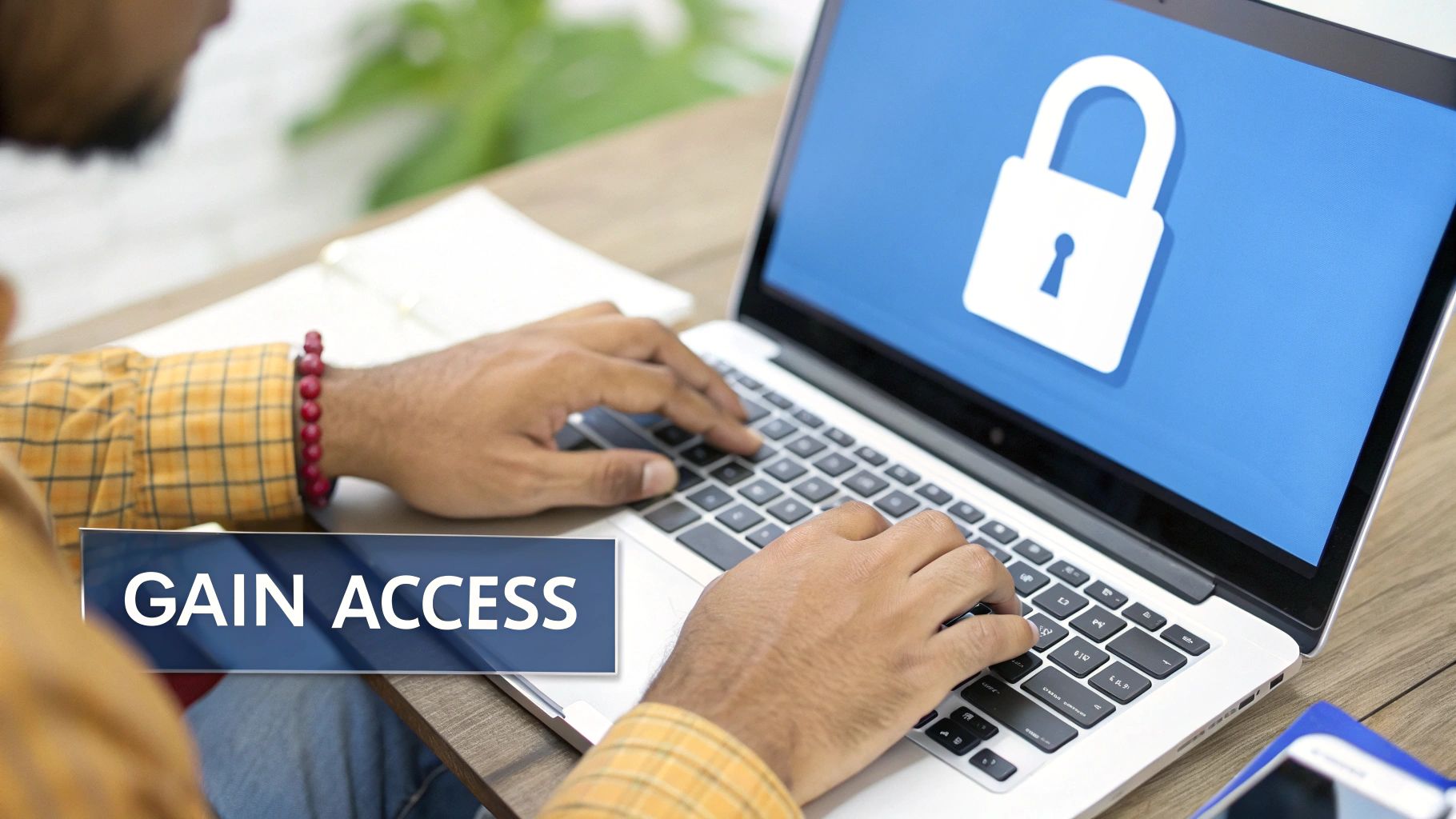 A person typing on a laptop screen displaying a large padlock icon and 'GAIN ACCESS' text.
