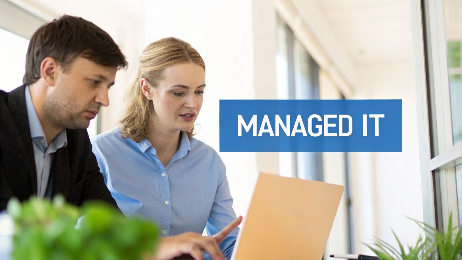 A team of IT professionals collaborating in a modern office, representing a managed services provider at work.