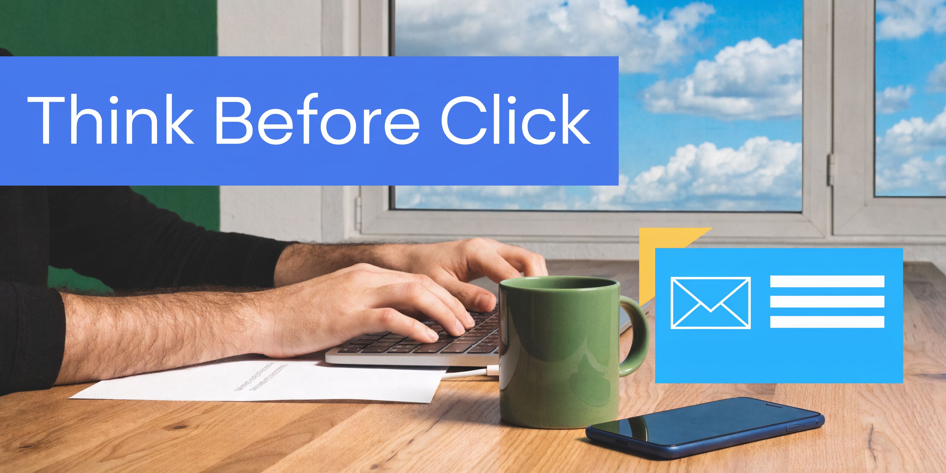 A person working on a laptop at a wooden desk with a coffee mug and phone.