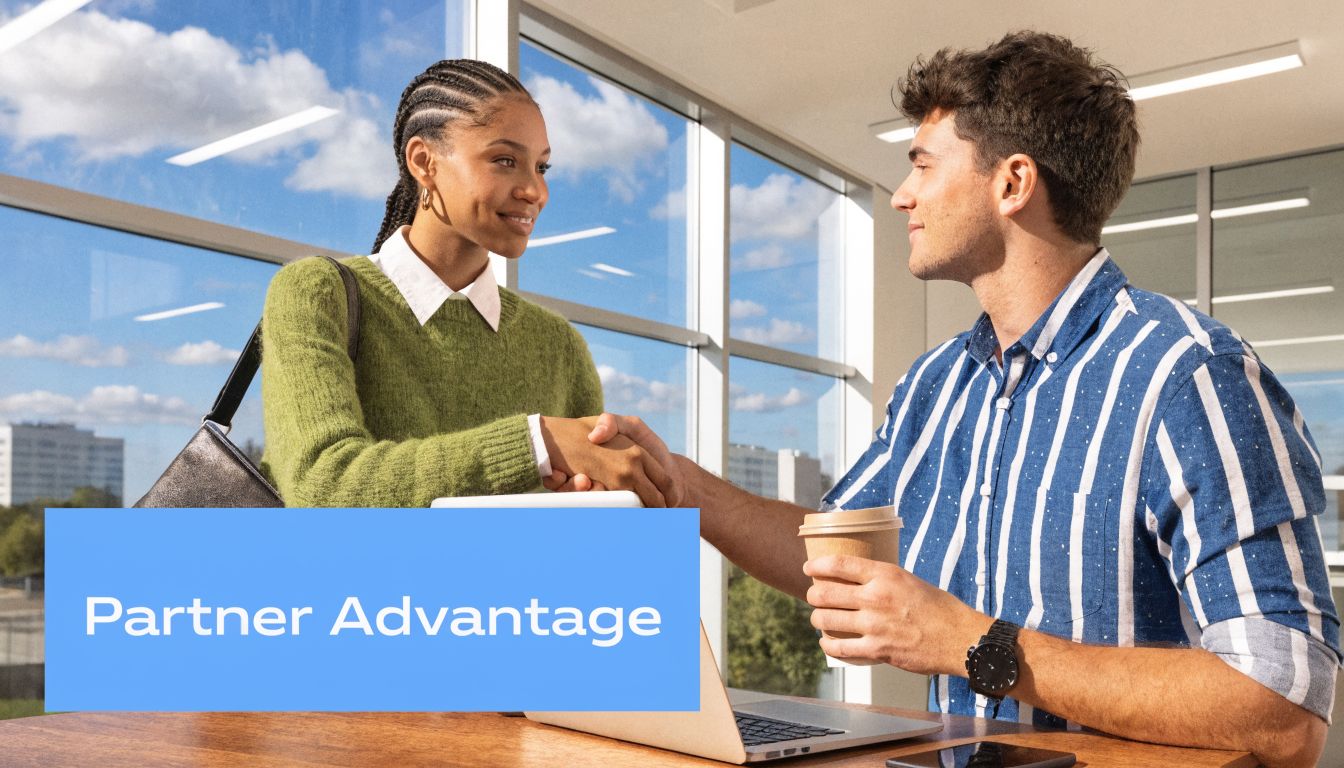 A professional woman and a man shaking hands over a table while collaborating in a modern office.