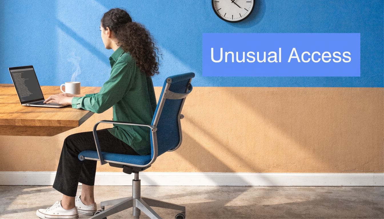 A person sitting at a desk with a laptop, reflecting on potential cybersecurity risks in an office.