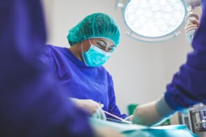 Person working surgical tech jobs during operation.