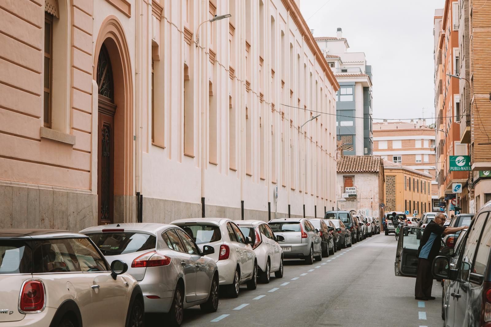 Rental cars parked on Spanish urban street - debit card car rental Spain