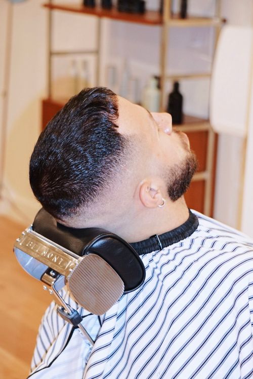 client in reclined barber chair