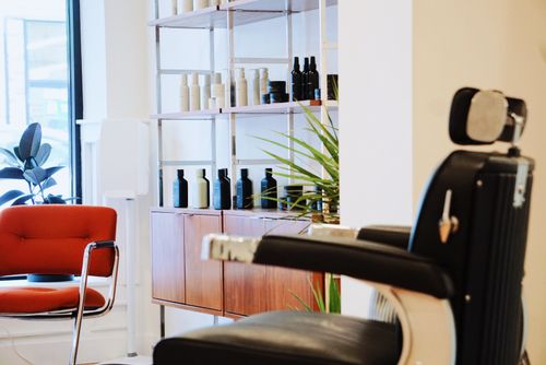 barber using hair products on client