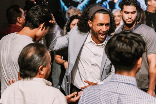 Michael Dow praying for someone