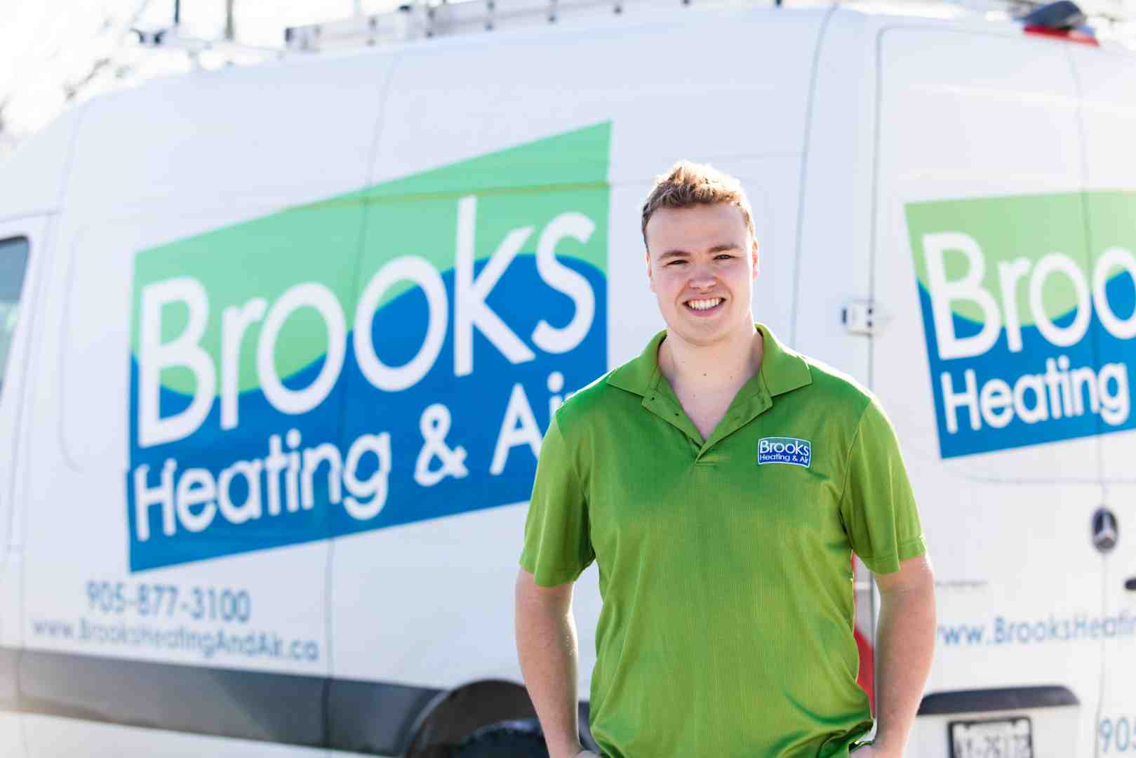 Friendly technician in branded uniform - Heat pump repair company Friendly technician in branded uniform - Heat pump repair company