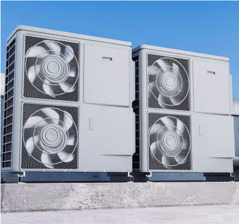 Two industrial air conditioning units with multiple fans against blue sky