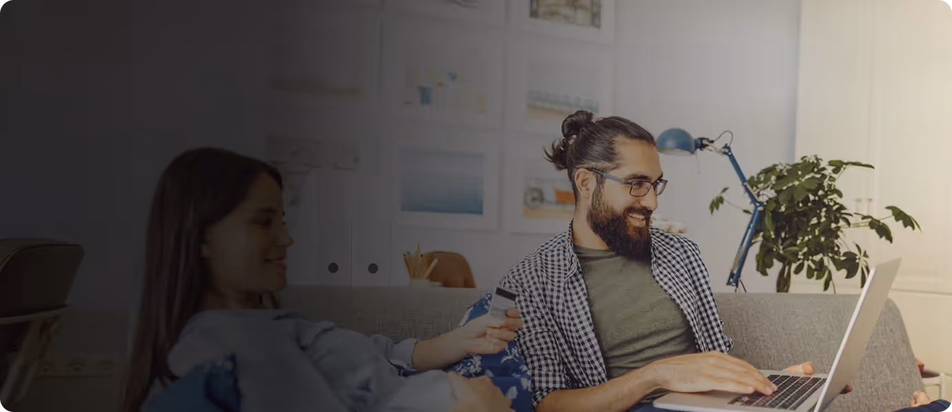 Two people working together on laptops in a bright, cozy home office.