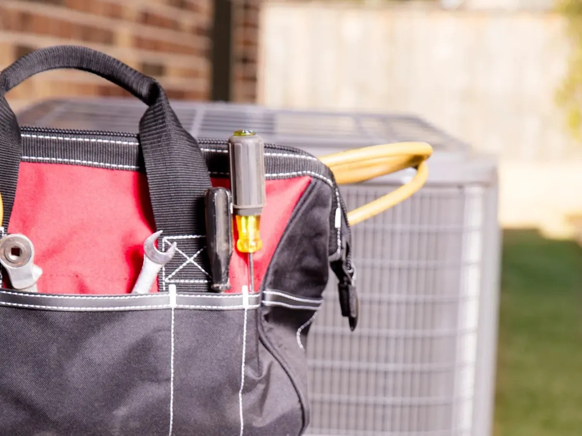 HVAC tool bag near AC unit – Residential HVAC in Olney, MD | ADI Heating & Air.