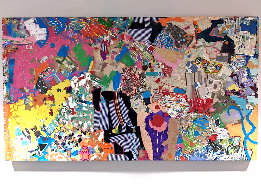 Colourful, mixed media artwork made with wood, various paper, and fabric. 