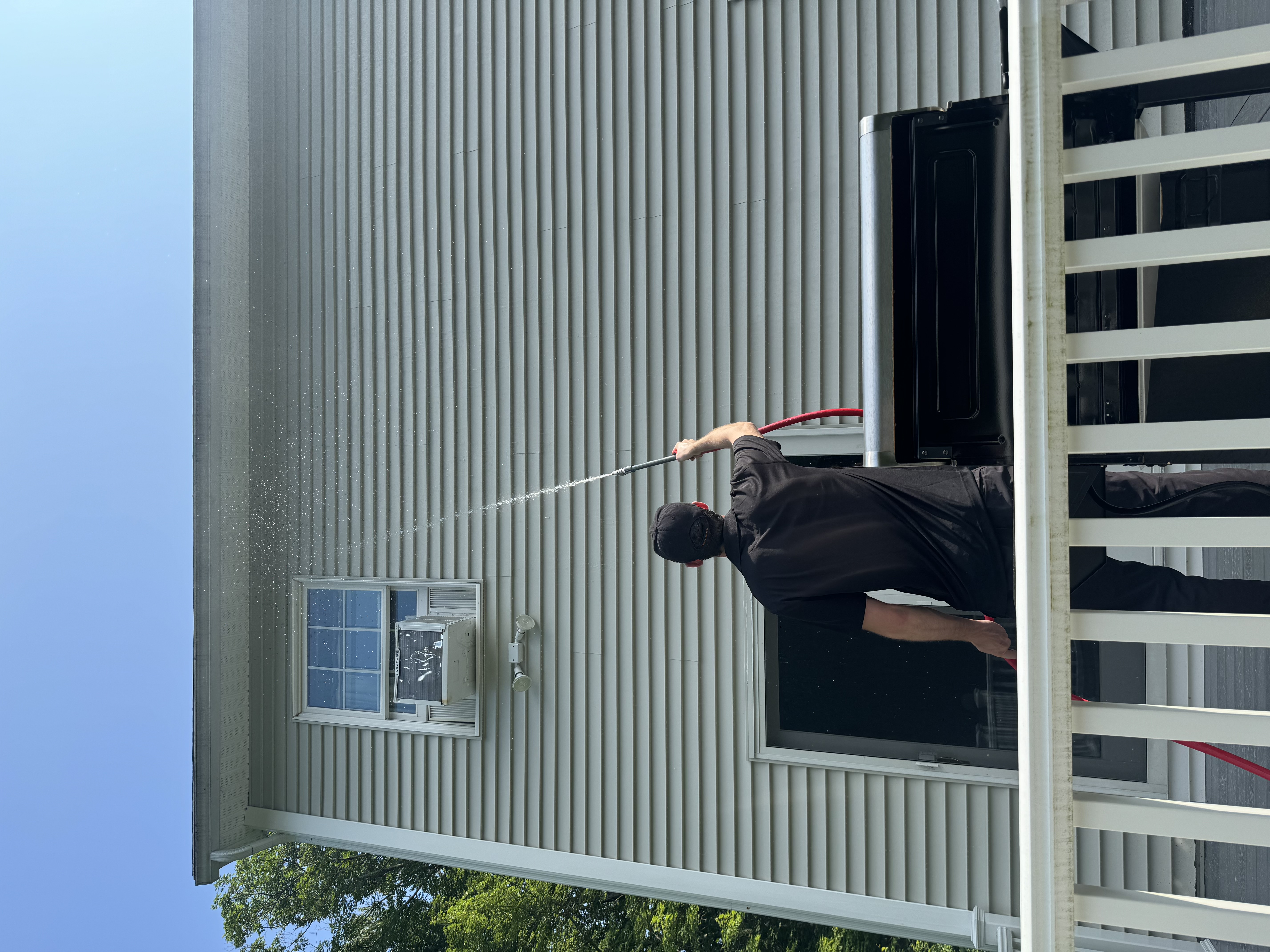 Gabe soft washing a home exterior in Seacoast NH