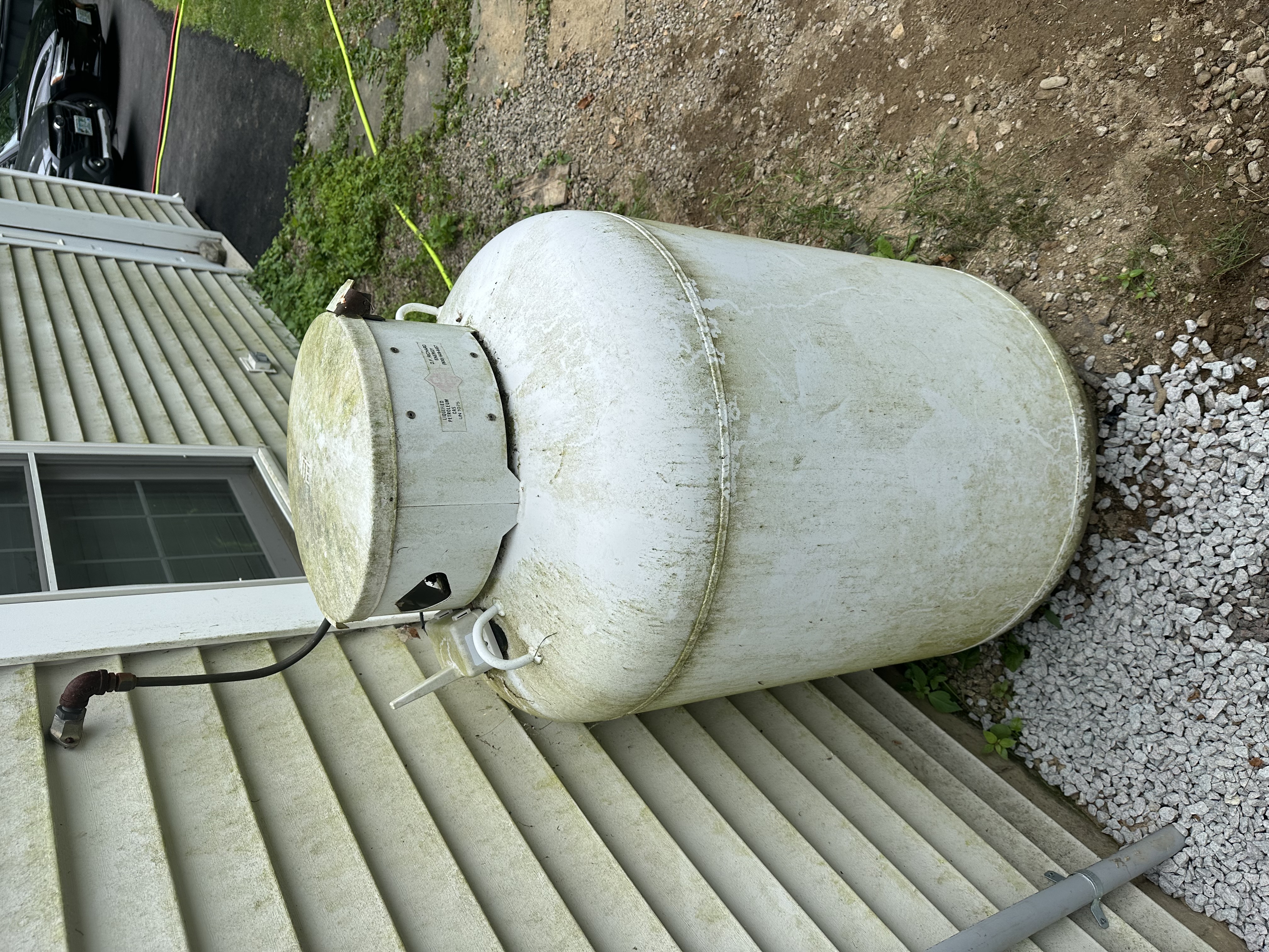 Propane tank and siding after pressure washing