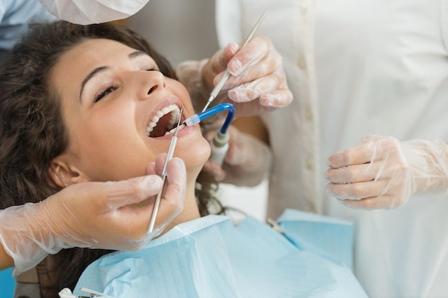 Dentist doing white dental filling treatment