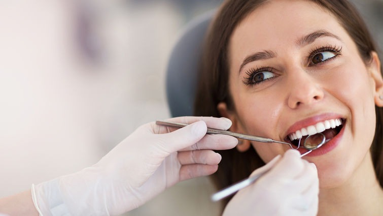 Smiling patient after cosmetic dental treatment with balanced gums and teeth