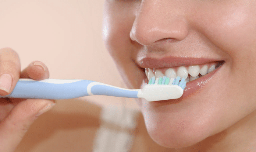 Daily veneer care with brushing flossing and non-abrasive toothpaste.