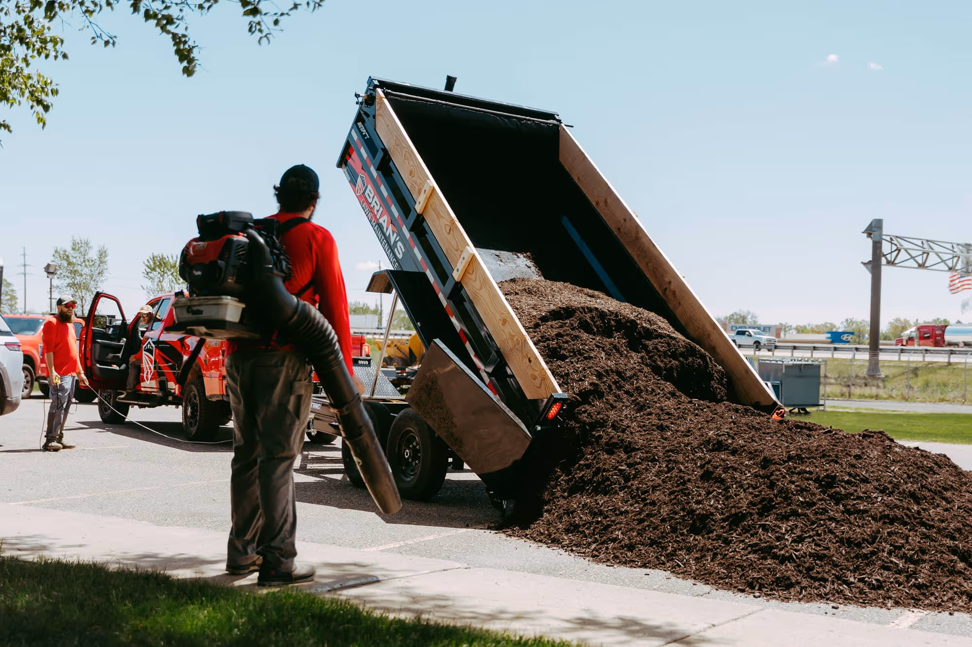 Landscape enhancement before-and-after at retail plaza in Wixom