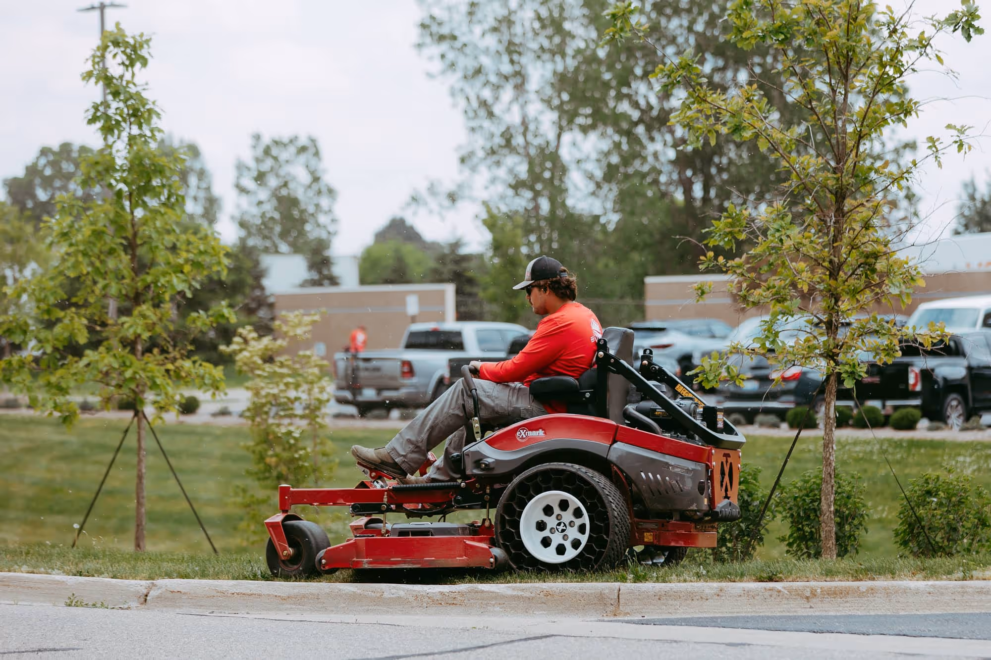 Commercial site management crew mowing office park lawn in Wixom, Michigan