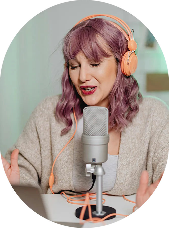 A woman wearing headphones while holding a microphone.