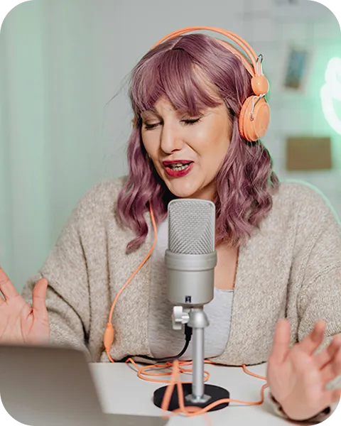 A woman sitting in a chair with a microphone.