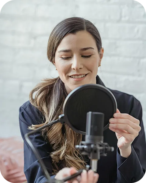 A woman sitting in a chair with a microphone.