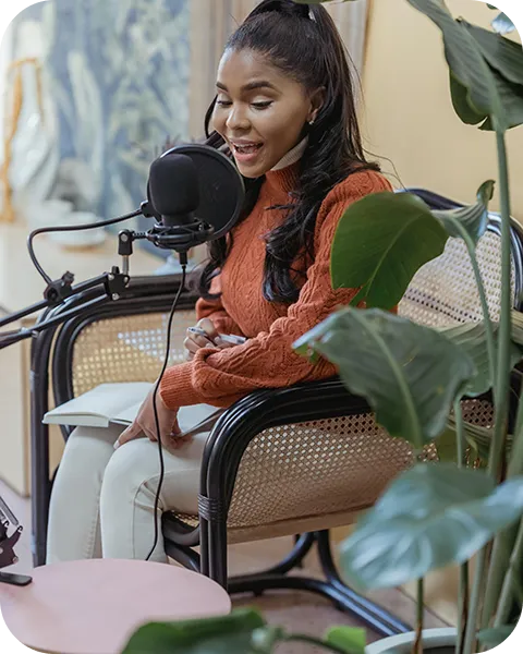 A woman sitting in a chair with a microphone.