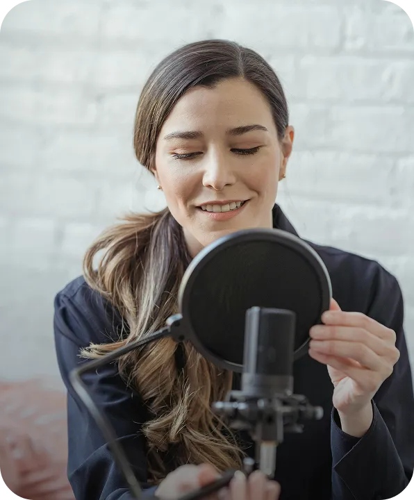 A woman holding a microphone up to her face.