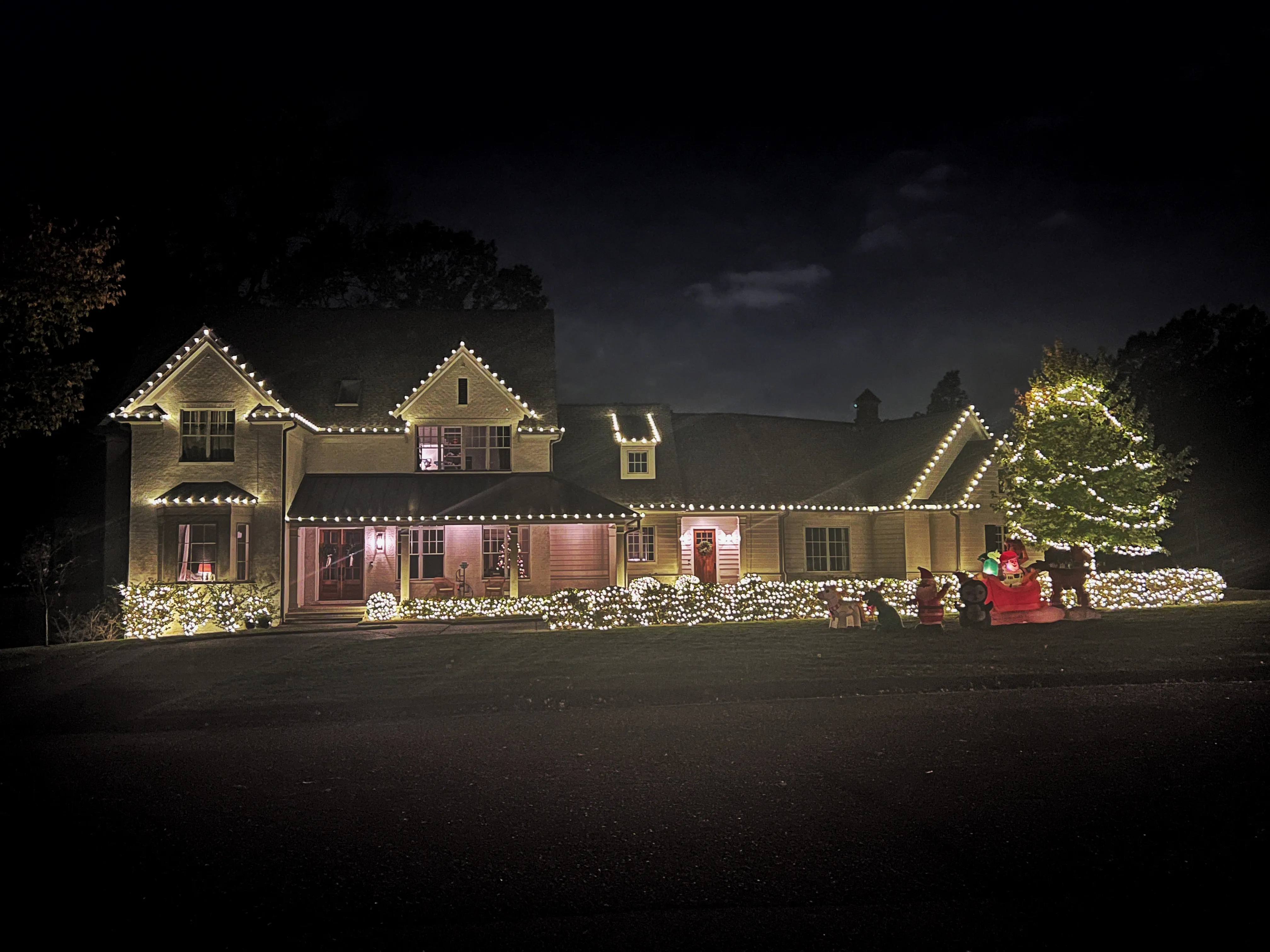 Home with roofline holiday lights at night